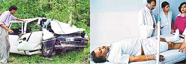 A relative of one of the victims, Ranjit Singh, examines the mangled remains of the car