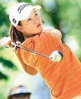 Thirteen-year-old Michelle Wie watches her tee shot 