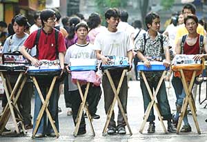 Chinese vendors sell pirated copies of DVDs and VCDs in Guangzhou, capital of Guangdong province