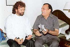 Jadugar Shankar Samrat changes a plain paper into five hundred rupee notes during a meeting with Hans Raj Hans at Chandigarh