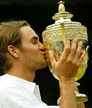 Switzerland's Roger Federer kisses the trophy after winning the men's singles title at Wimbledon