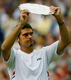 Australia's Mark Philippoussis holds aloft the runner-up trophy