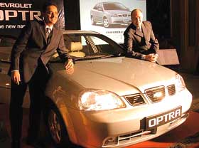 President and Managing Director of General Motors India Aditya Vij (L) and General Director of Sales Asia-Pacific of General Motors Terrence B. Johnsson stand beside the Chevrolet Optra Sedan during its launch in New Delhi on Monday.