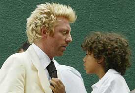 Former champion Boris Becker talks with his son Noah