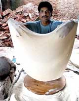 Abdul Rafique displays a 4-foot-diameter rumali roti
