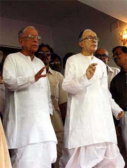 Veteran Marxist leader Jyoti Basu stands beside his wax model presented to him on his 90th birthday