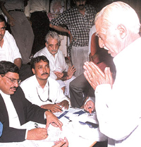 A shopkeeper pleads before the Special Metropolitan Magistrate during an MCD drive against encroachments at Lajpat Nagar in the Capital on Wednesday. 