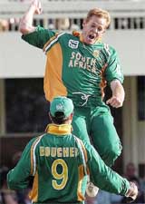 South Africa's Shaun Pollock celebrates the dismissal of England's Marcus Trescothick along with wicket-keeper Mark Boucher