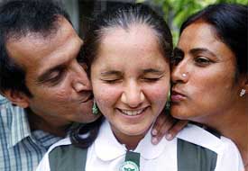 Sania Mirza gets a kiss from her parents, Imran and Naseem Mirza, in Hyderabad