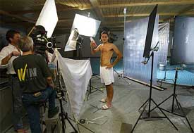 Wimbledon champion Roger Federer of Switzerland poses while shooting for a commercial
