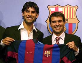 FC Barcelona's new Mexican defender Rafael Marquez and president Joan Laporta smile as they hold the team's jersey