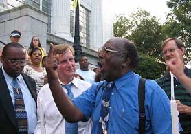 Rev. Sam Thompson of the 31st Avenue Baptist Church in Meridian, leads a candlelight vigil outside the City Hall with Mayor John Robert Smith