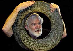 Helaman Ferguson explains his endless circle sculpture called 'Umbilic Torus' to mathematicians at the five-day International Congress on Industrial and Applied Mathematics