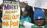 Protesters hold placards outside the US Embassy in Pretoria during a demonstration against President George W. Bush's visit to Africa