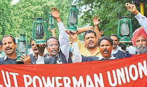 Members of the UT Powermen Union hold a protest rally in Chandigarh on Thursday.