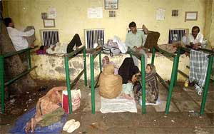 Visa seekers wait in advance outside the Pakistan High Commission's visa counter for the next day's booking