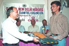 Sanjay of New Delhi Heroes Club being presented with a kit bag at a function