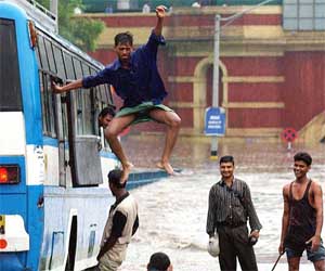 A man jumps through the emergency exit of a bus