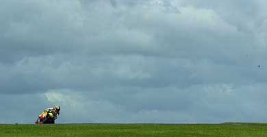 Italy's Valentino Rossi leans his Honda into a hairpin bend