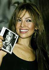 Latin music superstar Thalia poses with her first English CD, Thalia