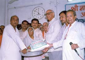 Mr Raghunandan Lal Bhatia, MP, distributes relief at the 71st relief camp held by Shri Gyan Sthal Mandir