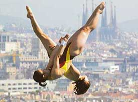 Koreans Min Kyung Kang and Hye Jin Choi dive during the women's preliminary platform synchro event