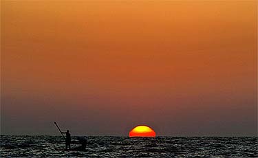 Palestinian fishermen cast their net into the waters of the Mediterranean Sea