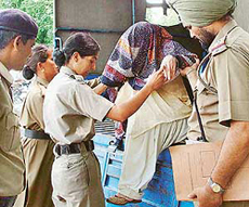 Dr Swapna Singh arrested by the UT Police in a murder case being produced in a local court by a lady constable in Chandigarh on Tuesday.