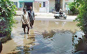 Factory workers have to wade through rainwater accumulated after a downpour in the Industrial Area, Phase II, Ram Darbar, Chandigarh, on Tuesday.