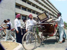 Lawyers shift their office furniture to the new judicial complex, near the Deputy Commissioner's office