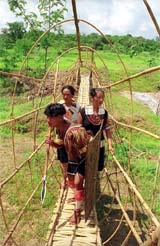 Chakhesang tribesmen from Pekh district of Nagaland walk past a newly erected bridge