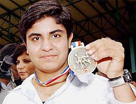 Geetika Jakhar, a member of the Indian  women's wrestling team, shows her gold medal 