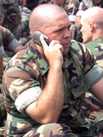US Marine Lance Corporal Toby Studabaker makes a last- minute phone call on his cell phone as he waits to embark a CH-46 helicopter at Camp Lejeune, North Carolina, in this September 20, 2001, file photo. 