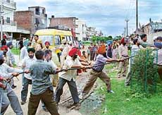 Employees of the Punjab State Electricity Board remove an electric cable