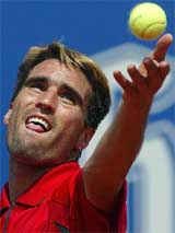 Germany's Tomas Behrend serves during his second round match against Spain's Carlos Moya