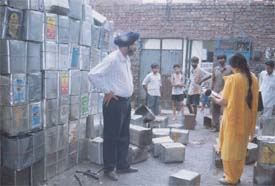Officials of the Punjab Pollution Control Board record the noise created by a tin factory
