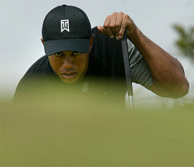 Tiger Woods of the US lines up a shot on the 14th hole on the first day of the British Open 