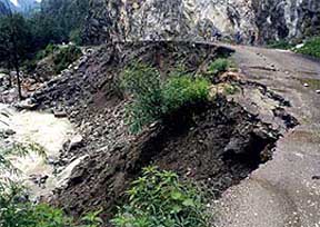 A view of the road which was damaged in the flash floods following a cloudburst at Pullia Nullah 