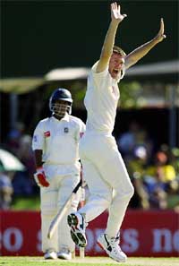 Australia's Glenn McGrath celebrates the wicket of Hannan Sarkar 