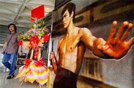 A visitor at the Hong Kong Arts Centre walks past a poster of Bruce Lee 