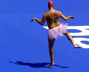 Mark Roberts, a professional streaker from Britain, dances while wearing a tutu