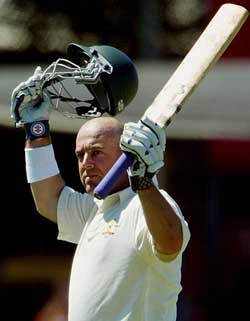 Darren Lehmann celebrates after reaching his century during the Test against Bangladesh in Darwin on Saturday