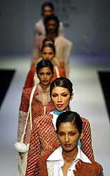 Models display outfits from Indian designer Anamika Khanna during the India Fashion Week in Mumbai