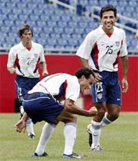 Landon Donovan of the USA is joined by teammates 