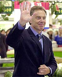 British Prime Minister Tony Blair waves to South Koreans during his visit to a Samsung Tesco store in Seoul