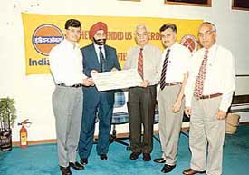 Indian Oil Corporation’s Executive Director, P.S. Ahluwalia hands over a cheque to Lt Gen Vijay Oberoi