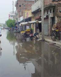 Accumulated rainwater at the Pakhowal road near a level crossing