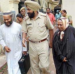 The British couple being produced at a court