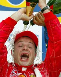 Ferrari's Brazilian rider Rubens Barrichello celebrates his victory at the British Formula One Grand Prix