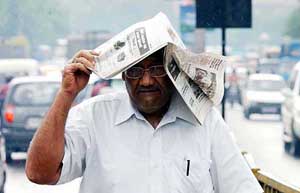A man tries to protect himself during a sudden downpour
